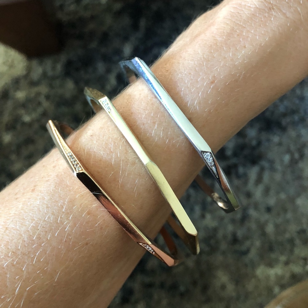 Kendra Scott three metal bangle bracelets.
